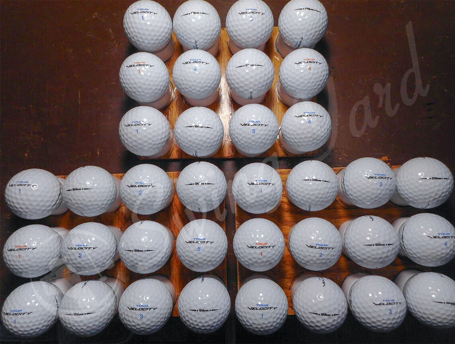 The Wilson Tour Velocity balls on the floor