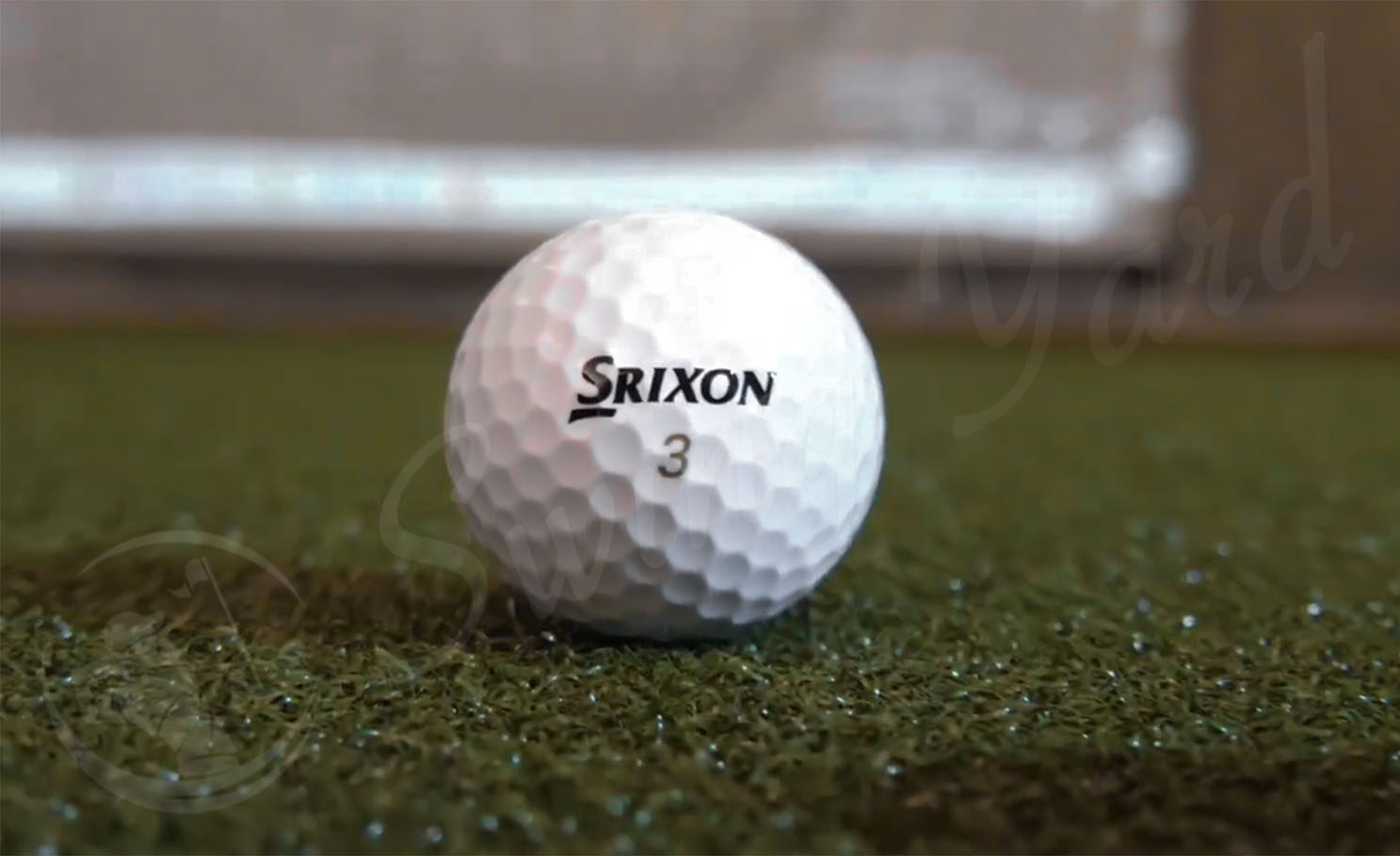 A number 3 Srixon Z-Star ball at the golf simulation room