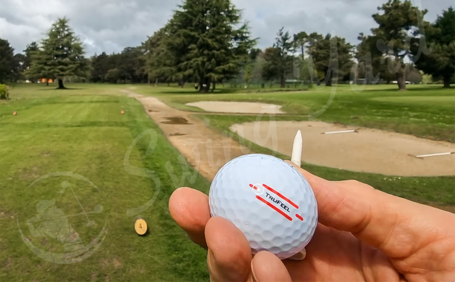 A Titleist TruFeel ball in my hand at the golf course