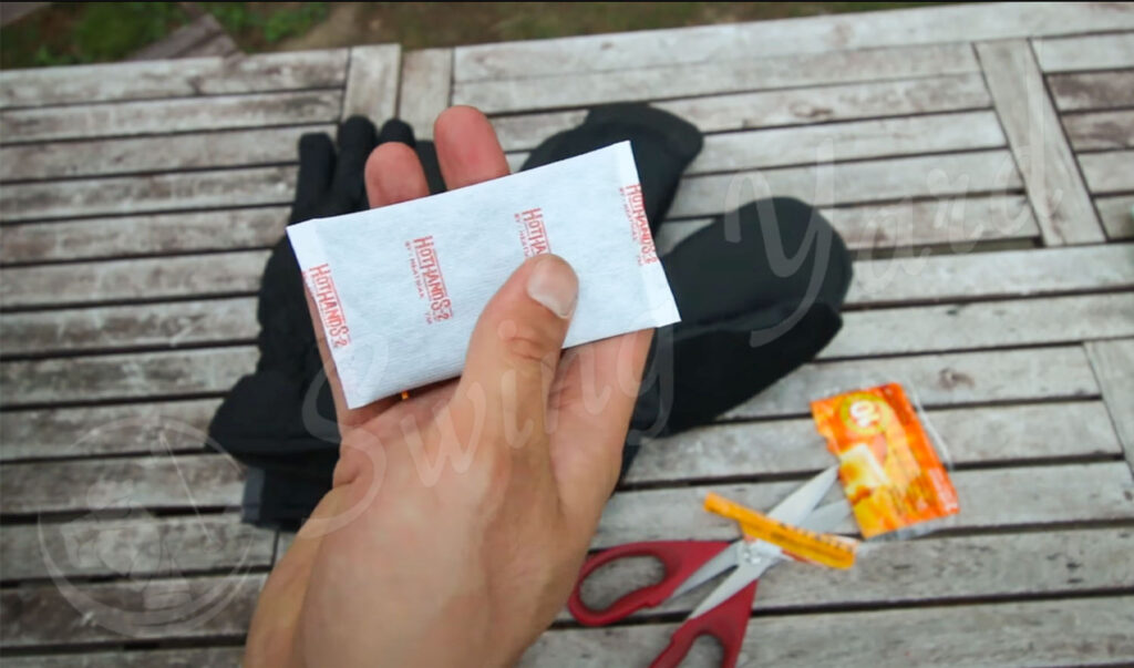 Me holding a Hot hands golf hand warmer in my backyard