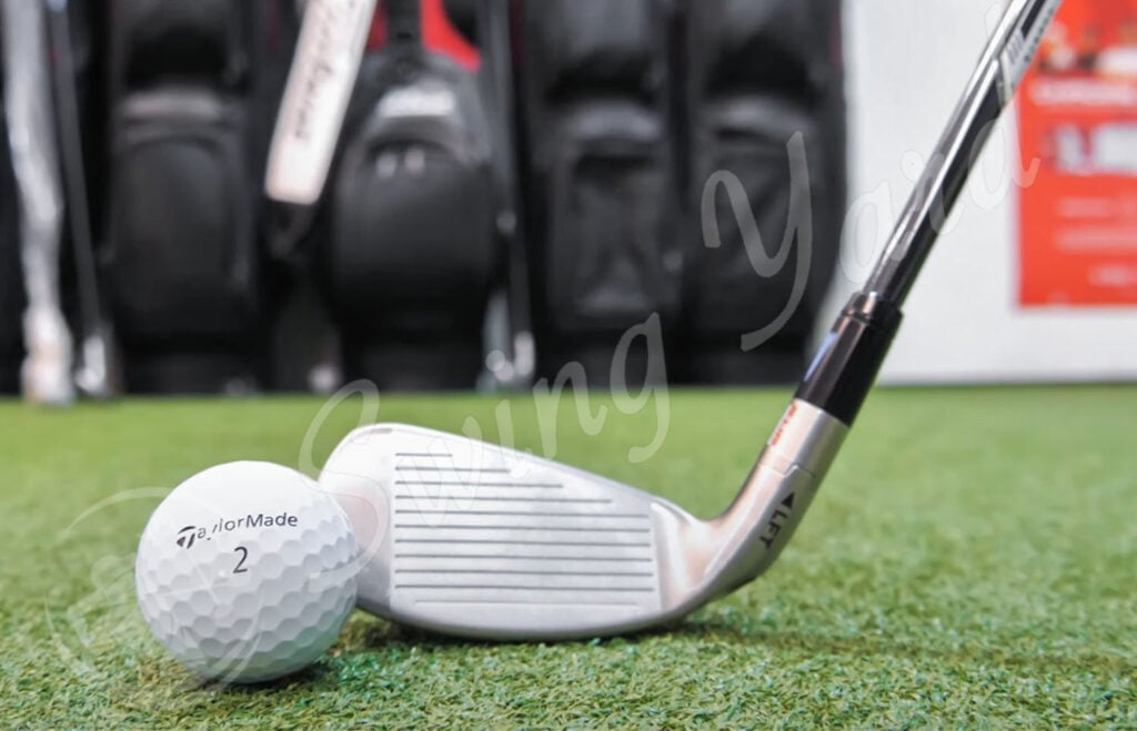 My TaylorMade Stealth HD Women Iron hitting a golf ball at the golf simulation room