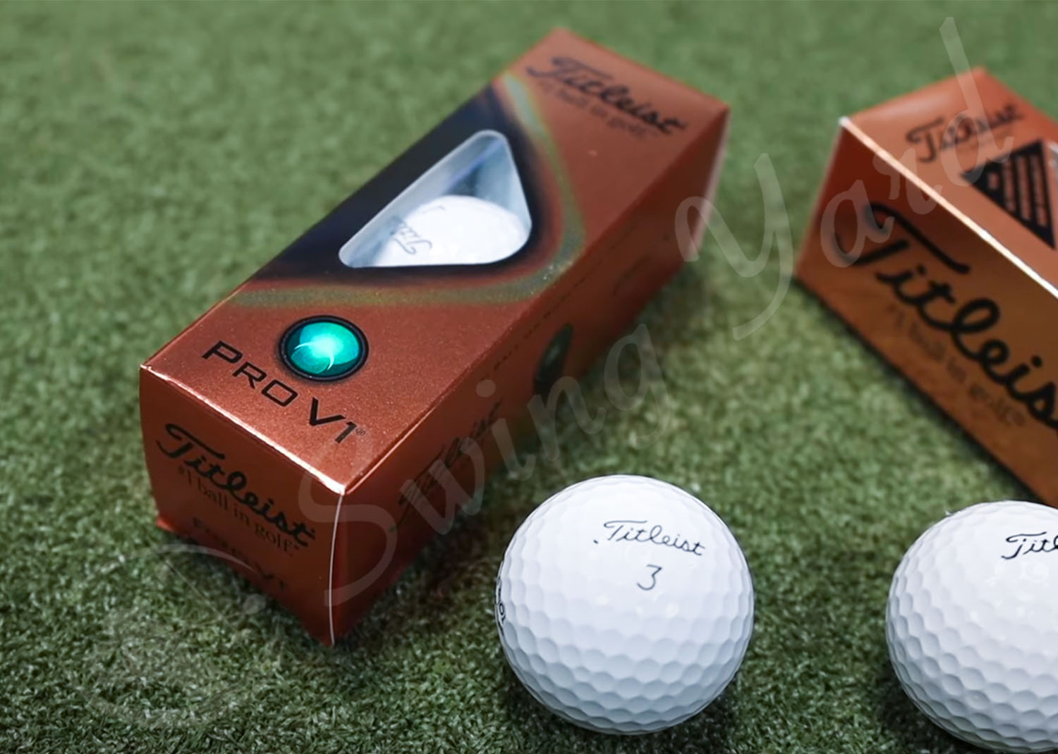 The Titleist Pro V1 single pack and a ball in the grass
