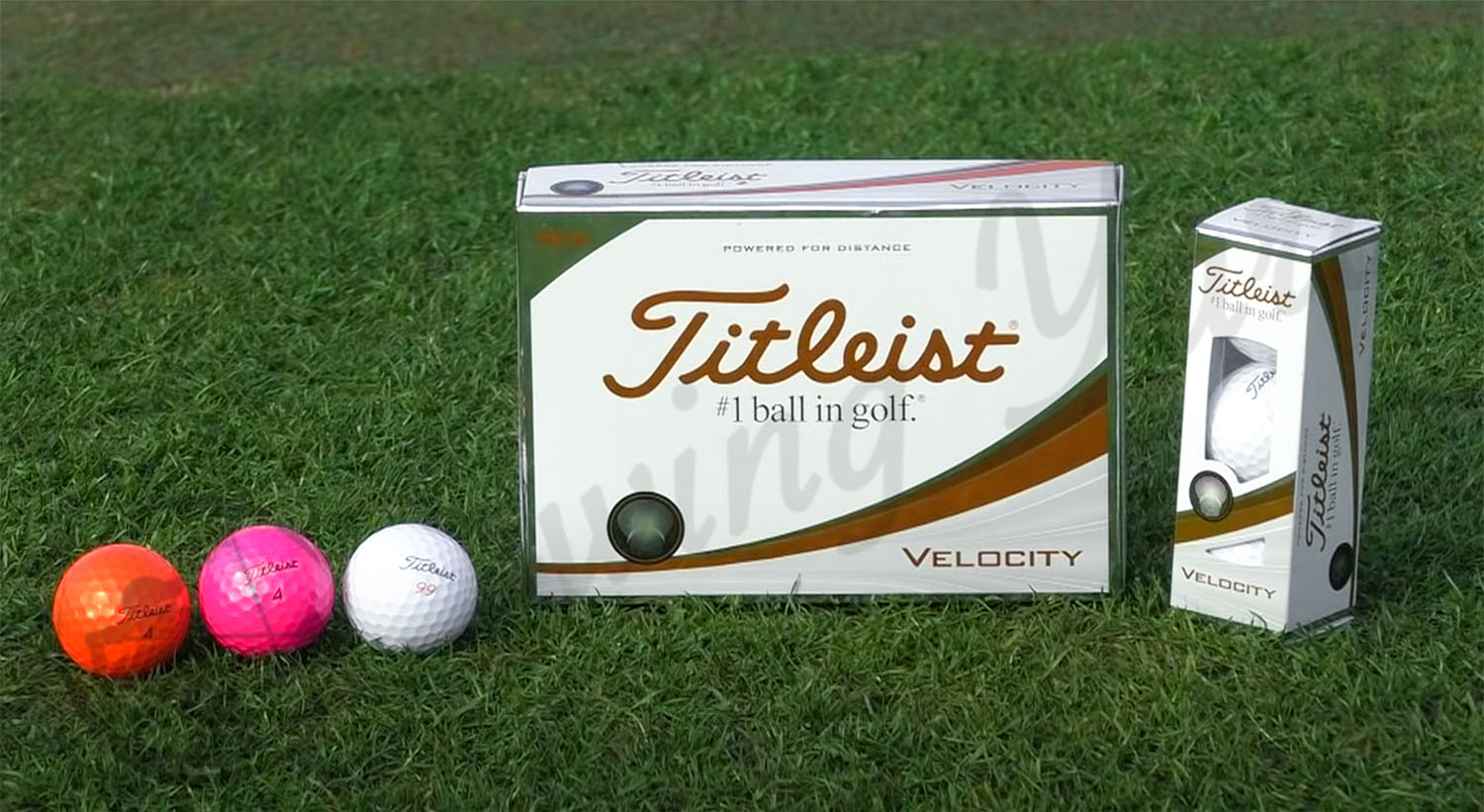 A Titleist Velocity box in the grass at the golf course