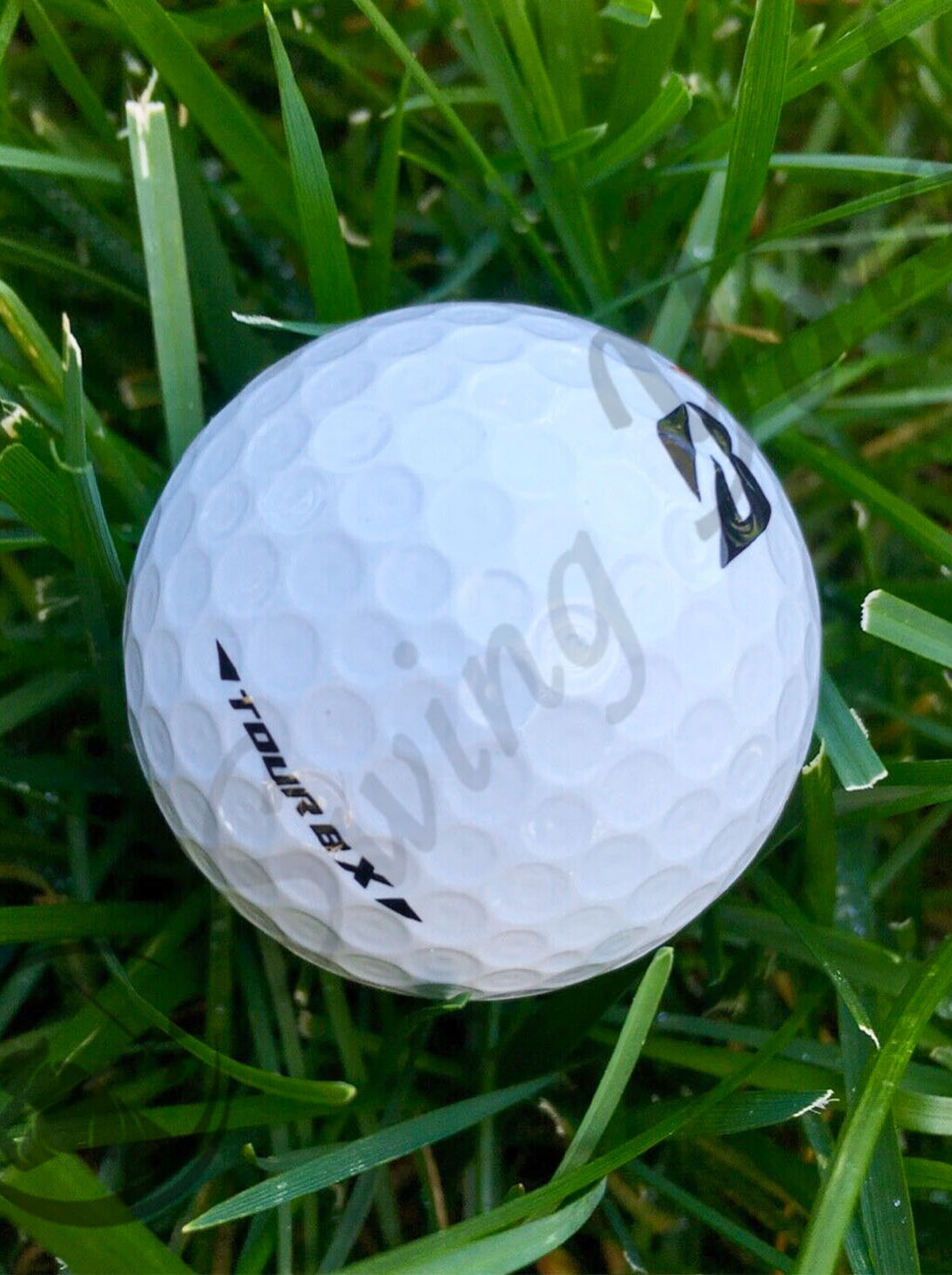 A Bridgestone Tour BX ball in the grass