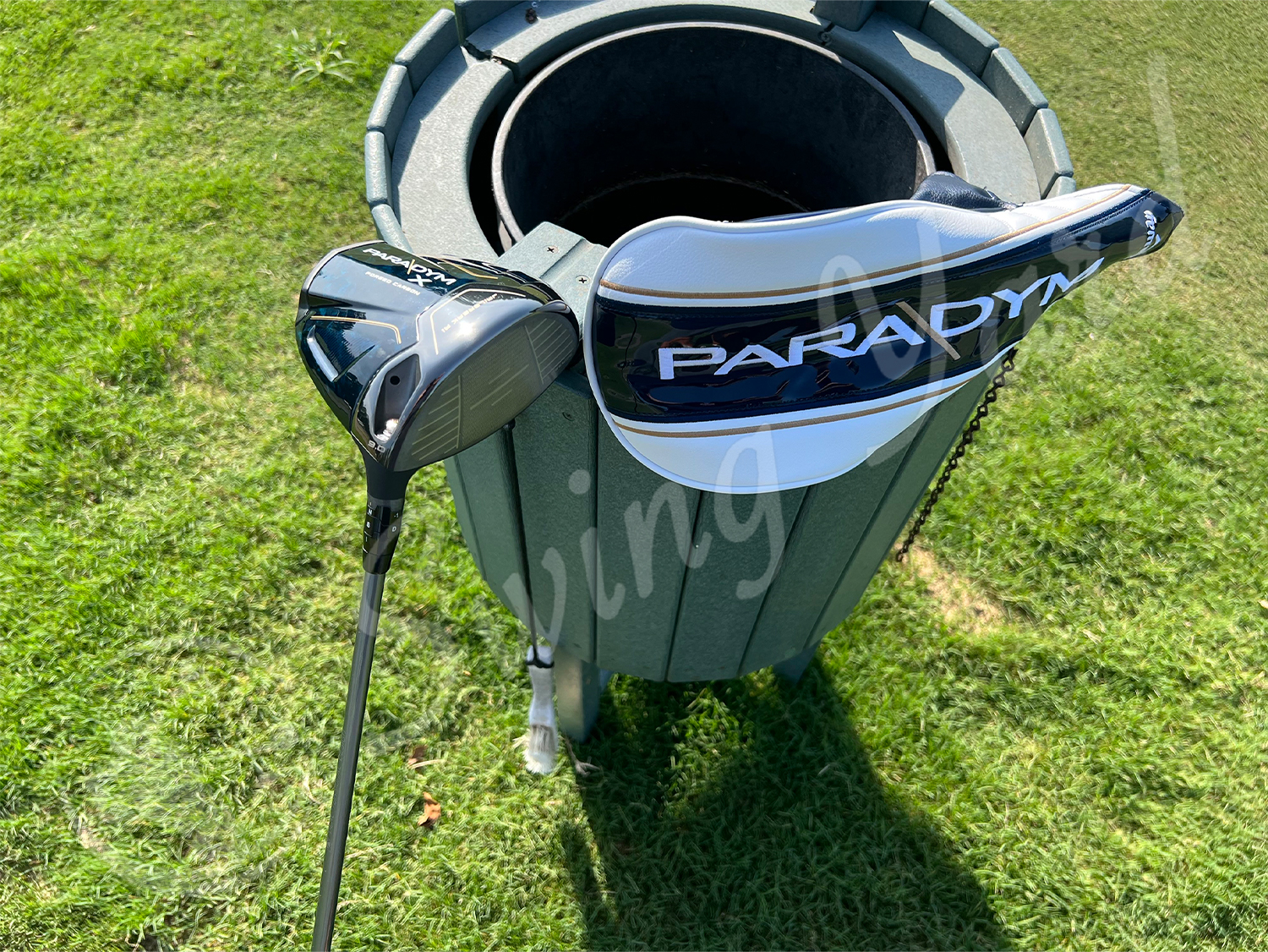 A Callaway Paradym X driver and headcover in the golf basket at the golf course