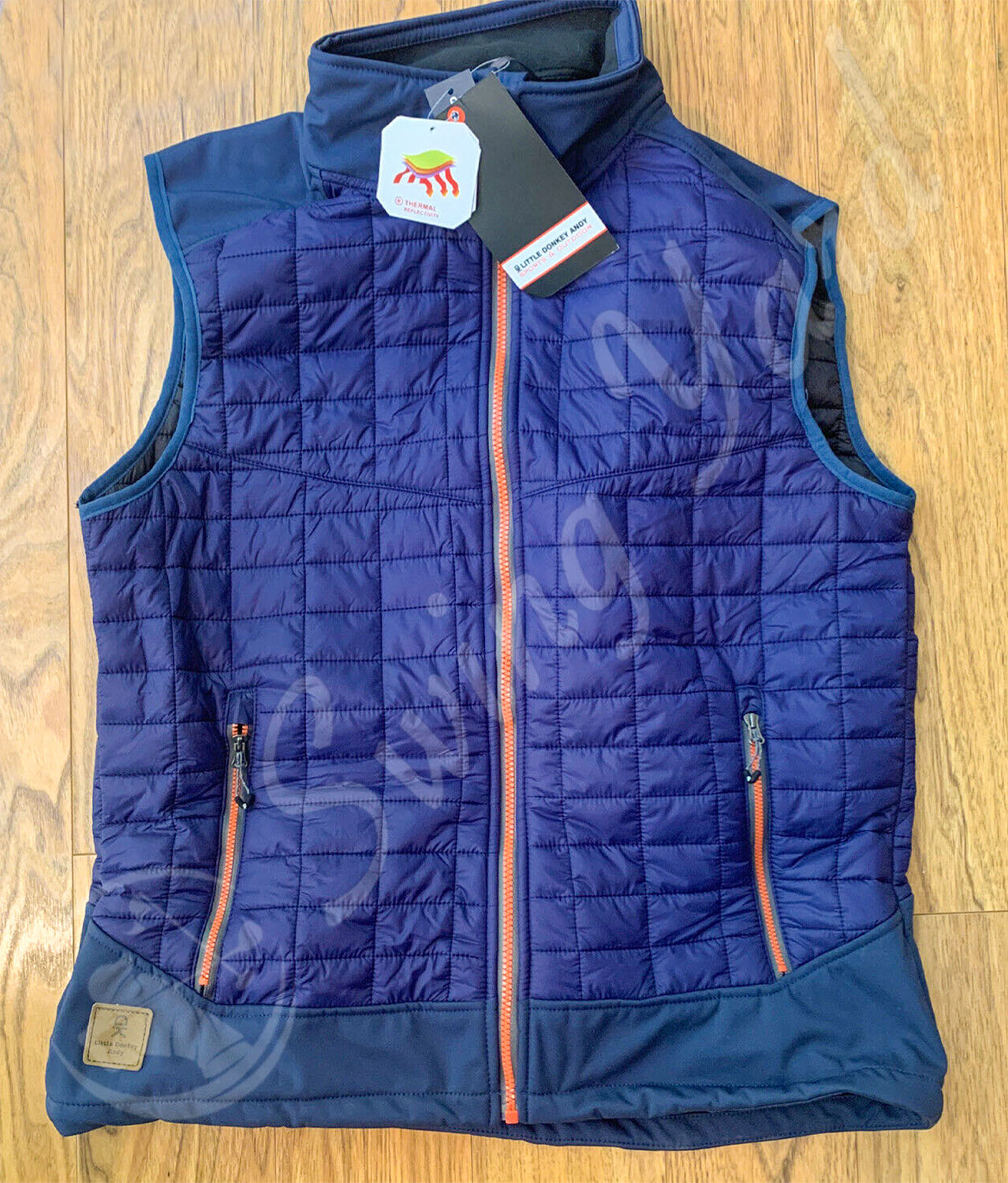 My new blue Little Donkey Andy lightweight puffer vest on the floor