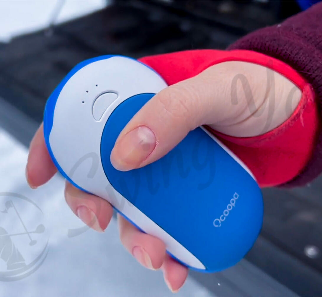 Me holding OCOOPA Rechargeable hand warmer in the yard