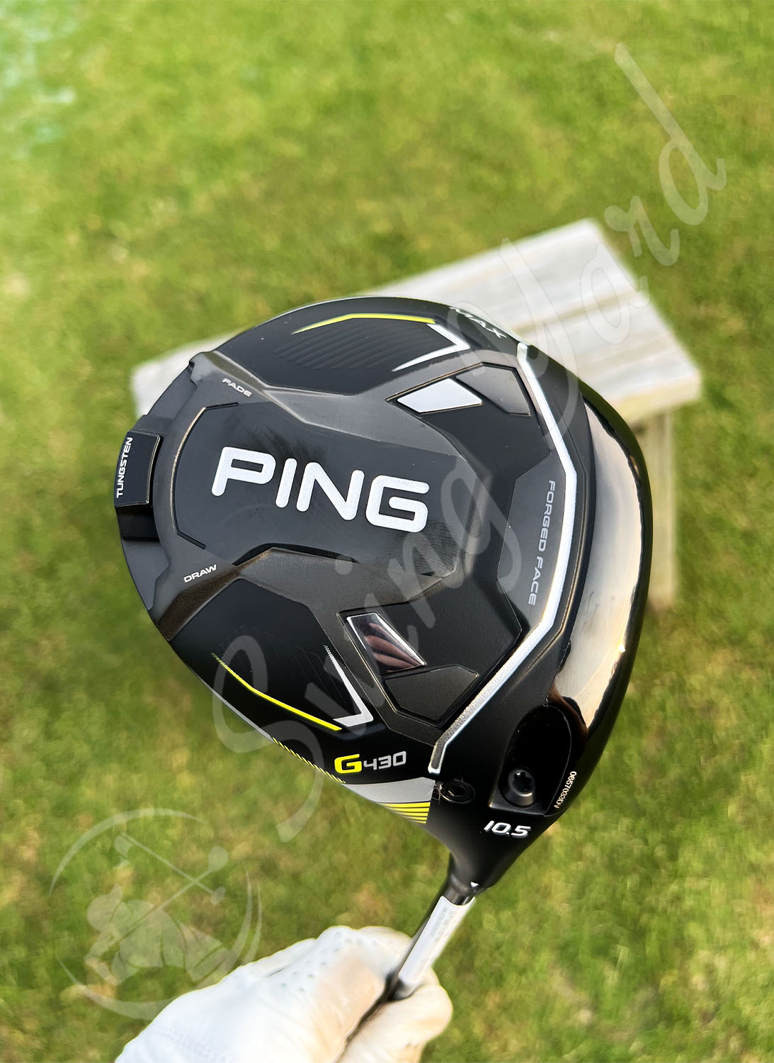 Me holding a Ping G430 max driver for testing at the golf course