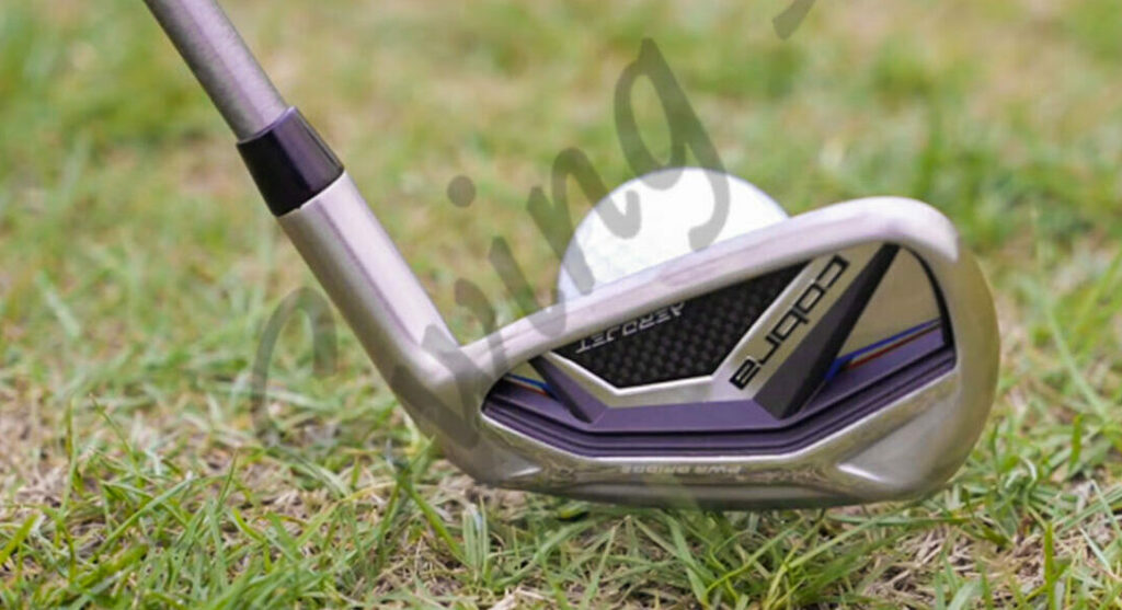 My Cobra AeroJet Iron hitting a golf ball in the grass at the golf course