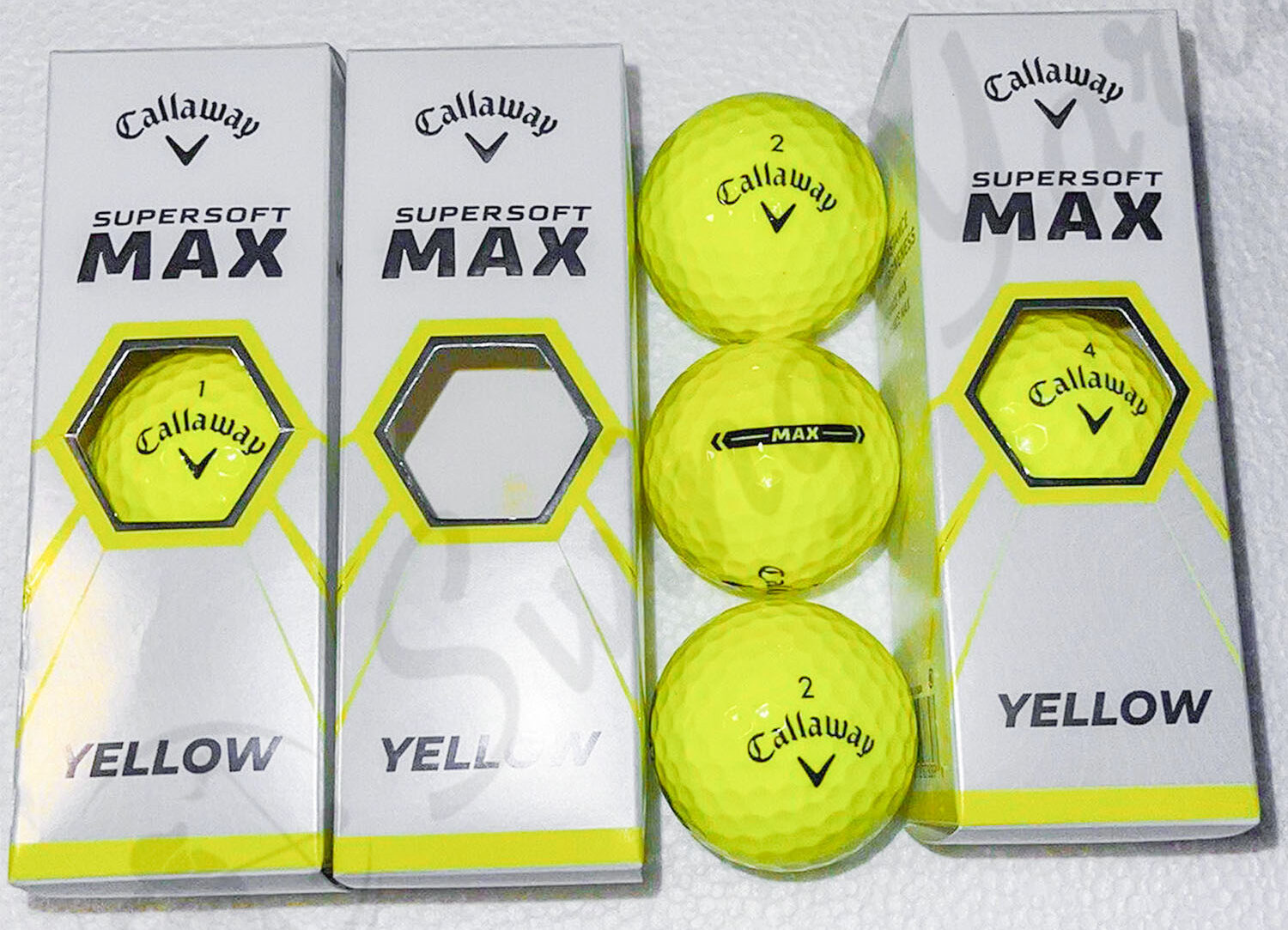 The Callaway Supersoft Max single packs and yellow balls at the table