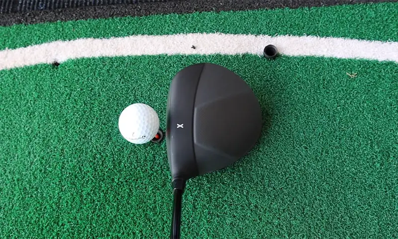 PXG lined up to hit a ball