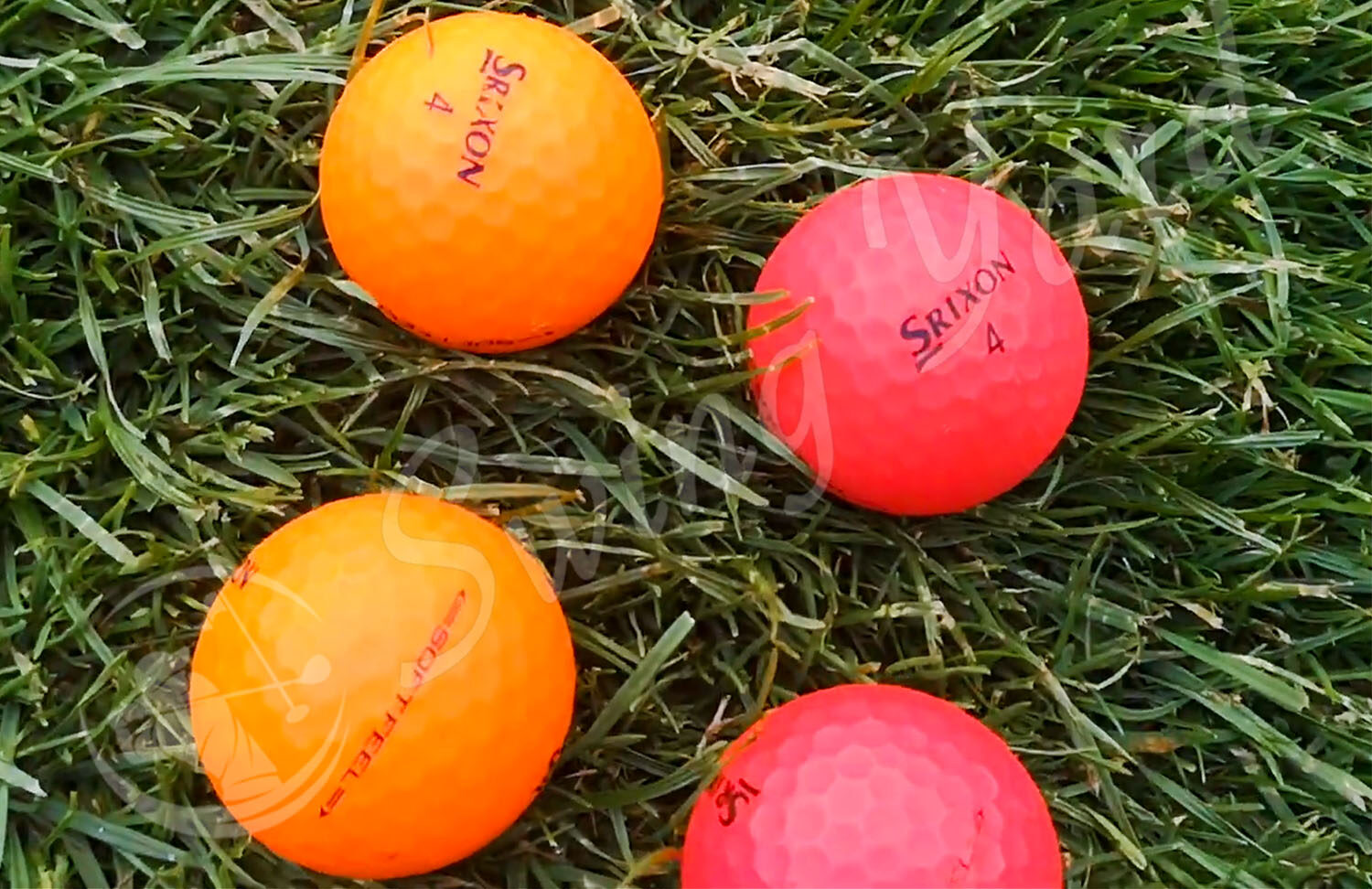 The Srixon Soft Feel red and orange matte in the grass