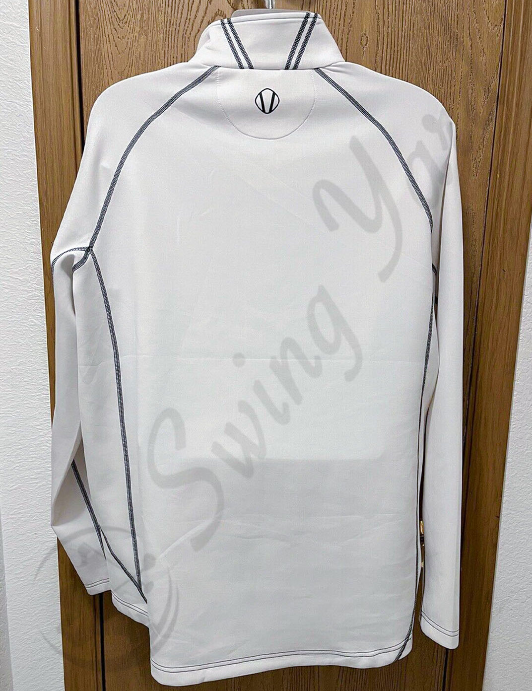 A white Sunice allendale men’s thermal golf jacket pullover backside view hang on the door