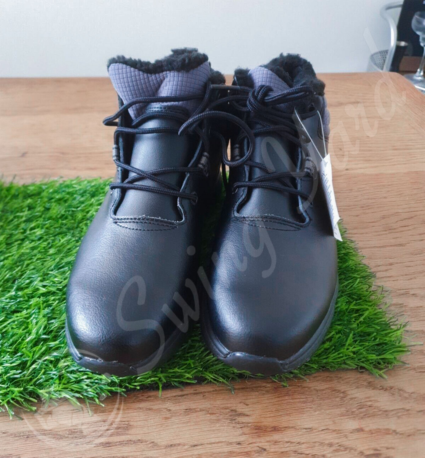 A front side view of FootJoy women golf boots on the the artificial grass mat