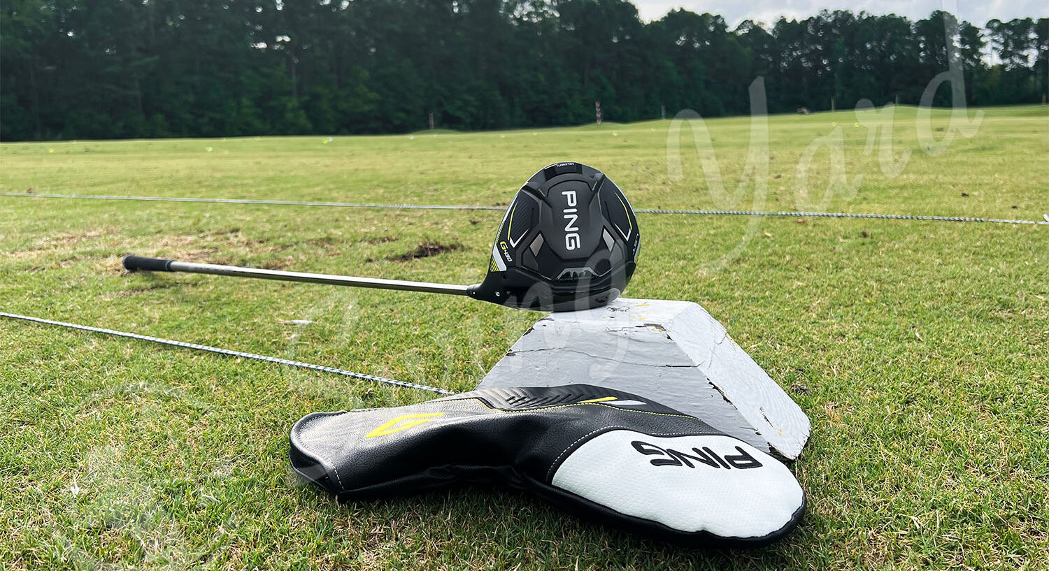 The Ping G430 LST Driver and headcover in the grass at the golf course