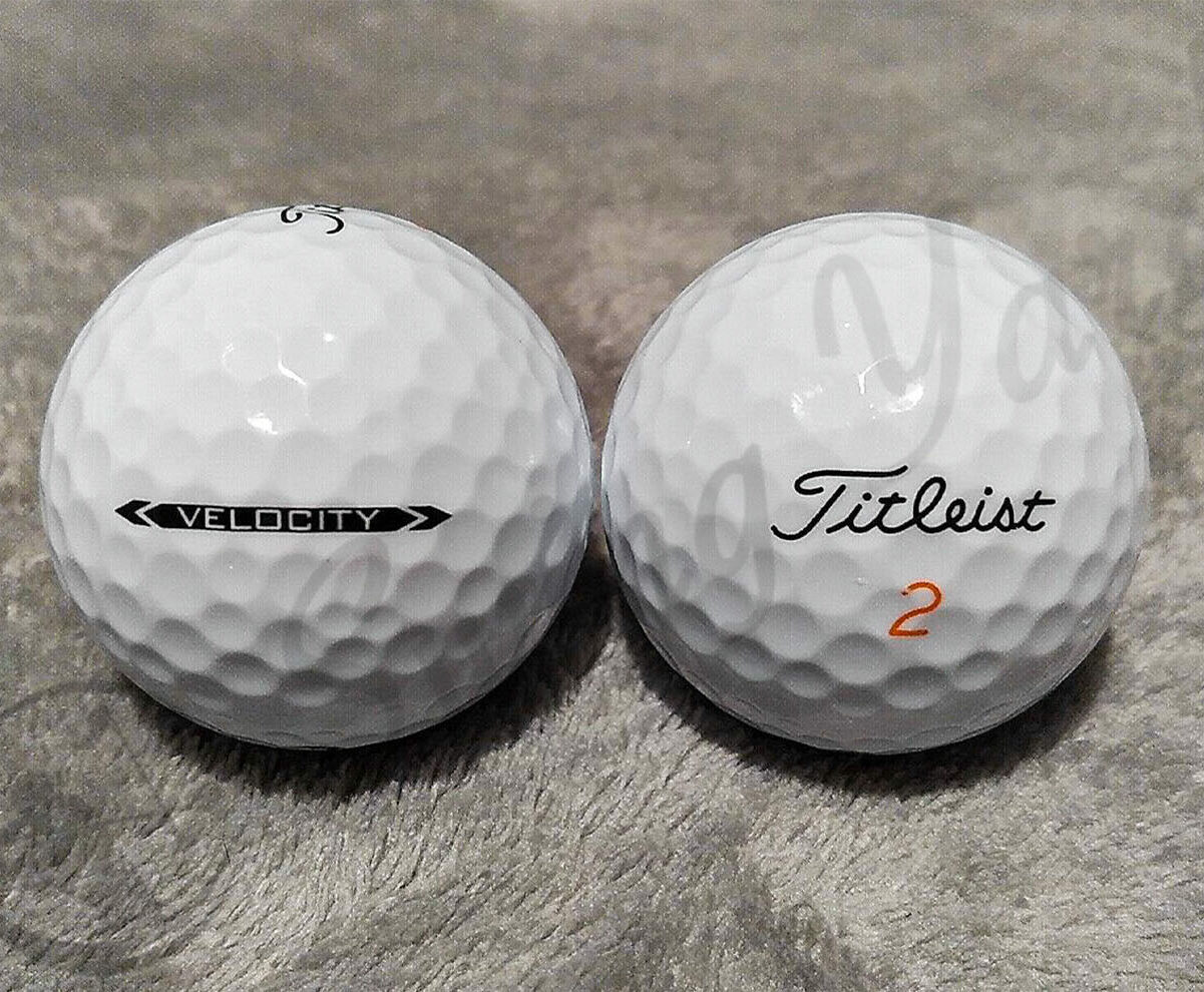 The frontside and sideview of Titleist Velocity balls on the floor