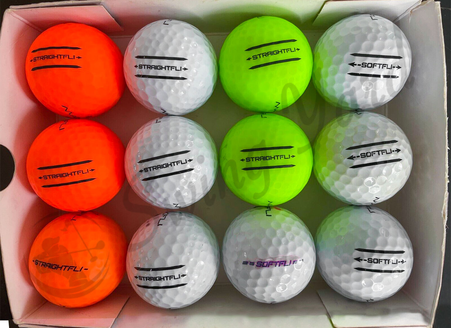 The mix color of Maxfli StraightFli balls inside the box