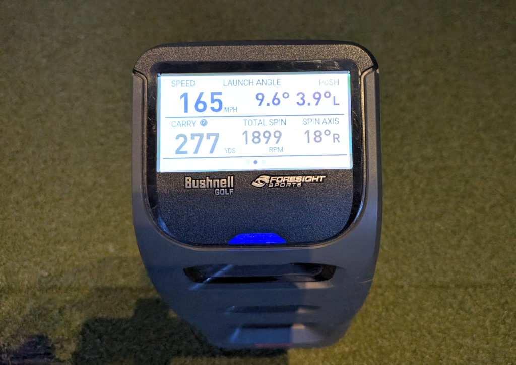The Bushnell Launch Pro launch monitor showing ball data from and indoor golf simulator driver swing