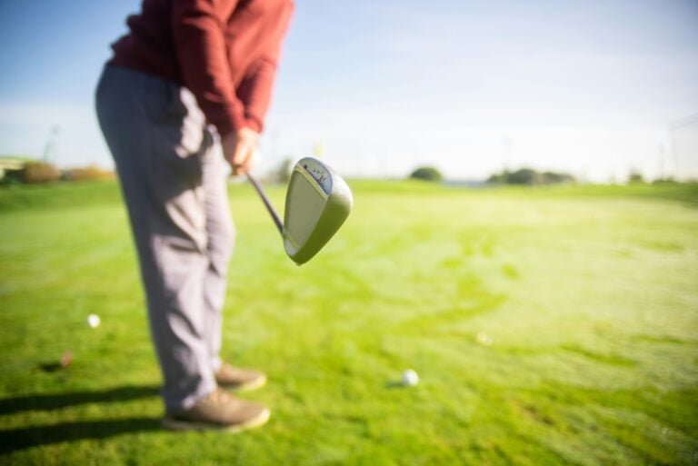 A golfer taking the club back in his backswing