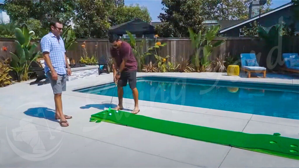 Friends playing with the Battle Putting set by the pool