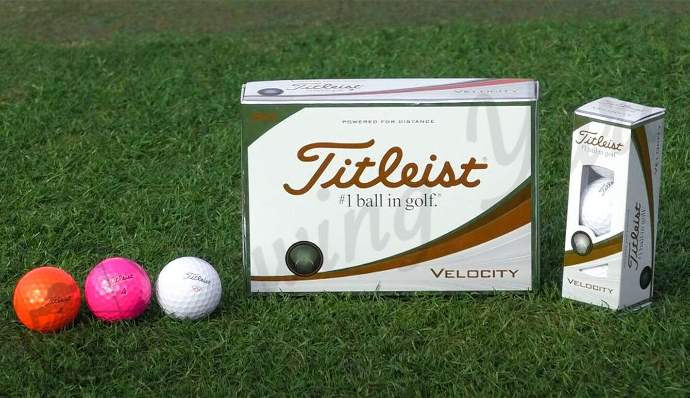 The Titleist Velocity golf balls in the grass at the golf course