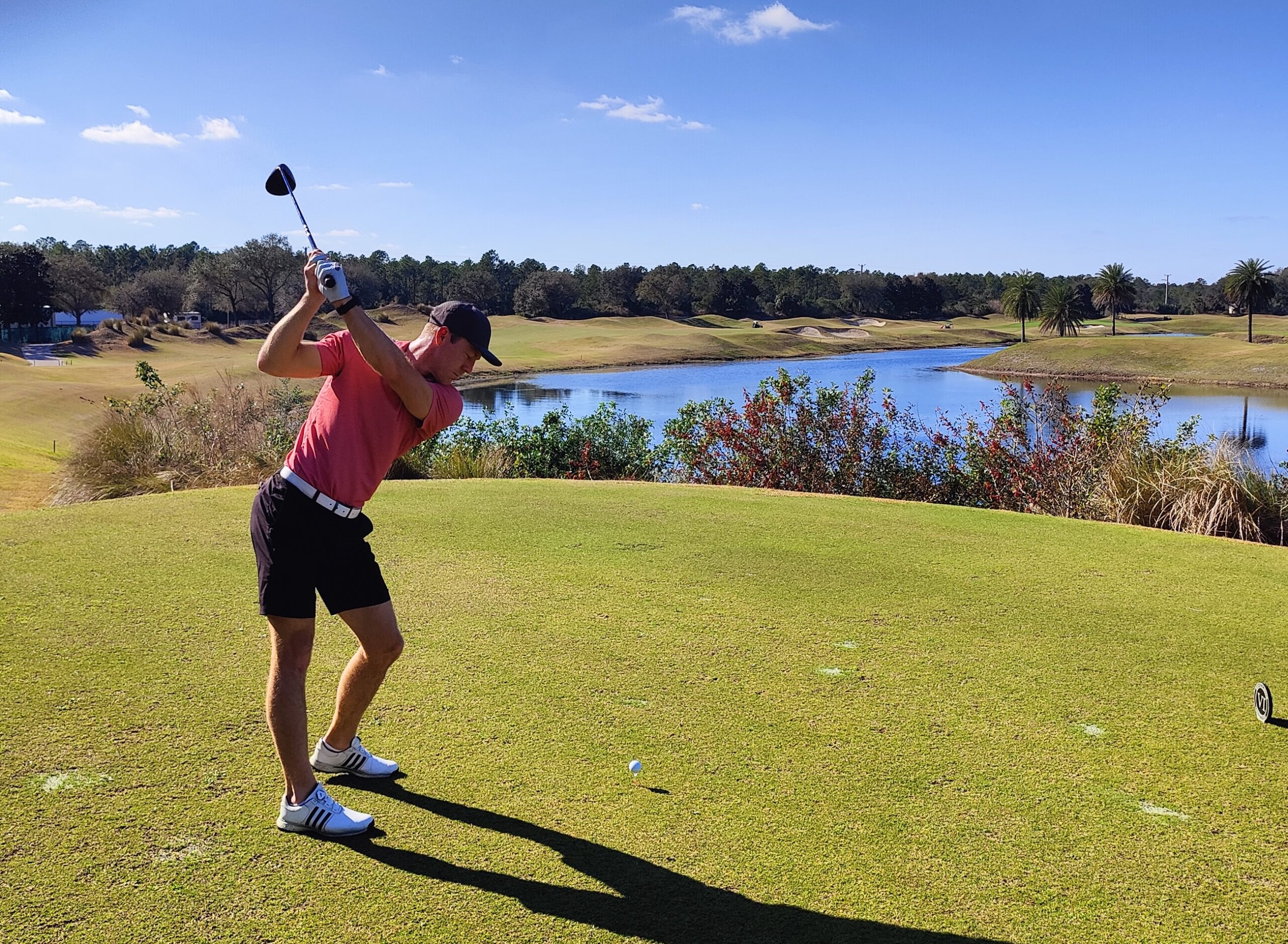 Swing Yard coach Brian hitting a driver while displaying how to shallow the golf club