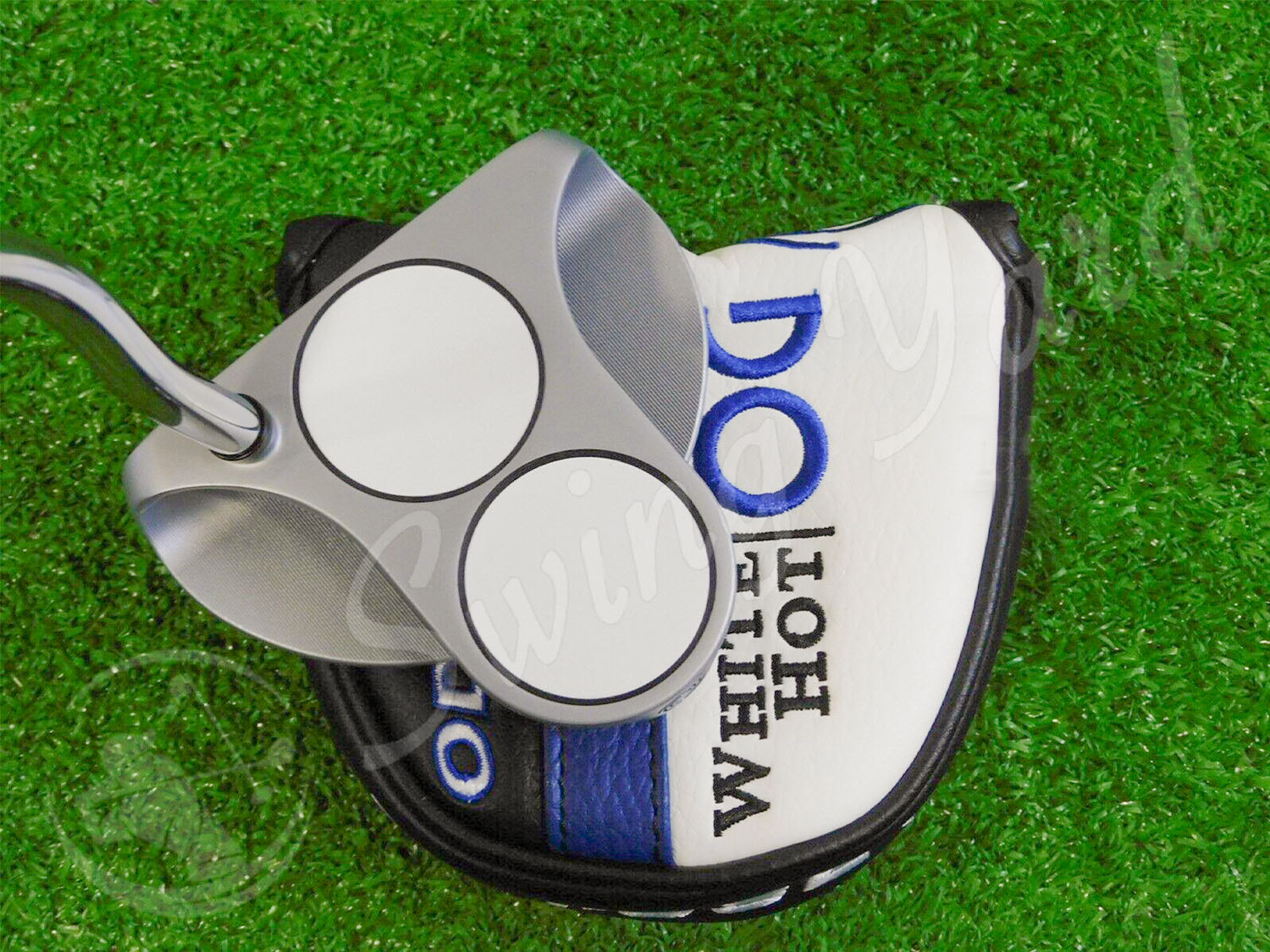 The Odyssey White Hot OG 2 Ball Putter with headcover at the range