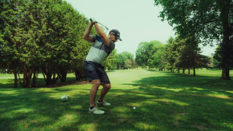 golfer taking a full swing off the tee to compress the golf ball