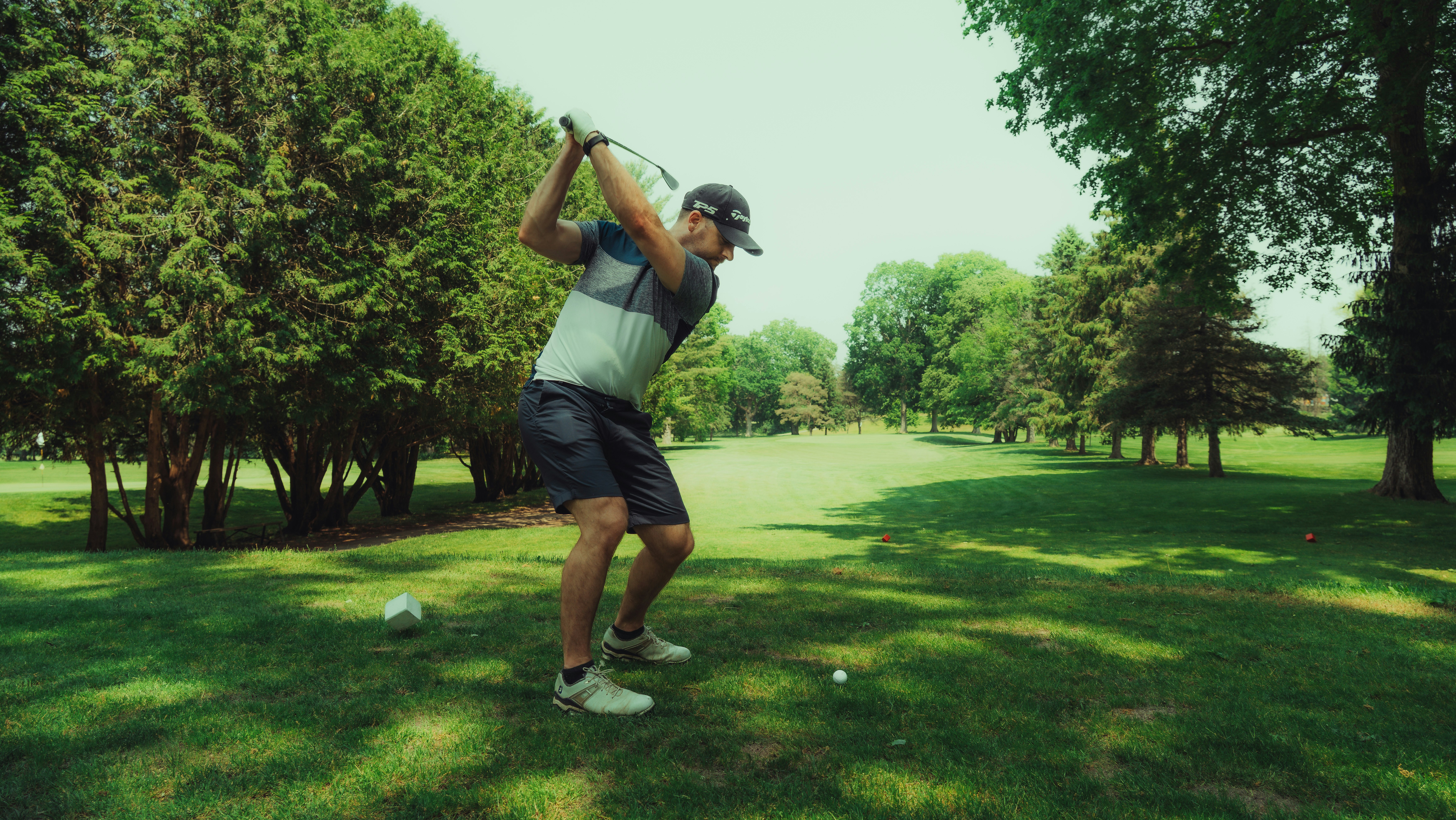 golfer taking a full swing off the tee to compress the golf ball