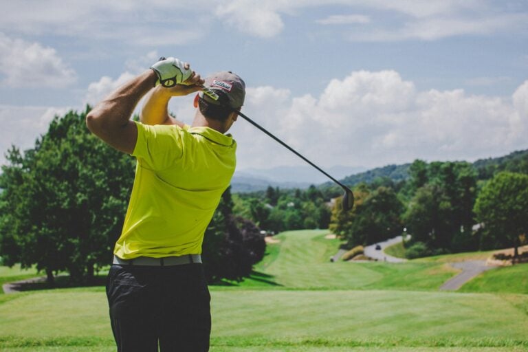golfer hitting a fairway wood off the tee into the fairway