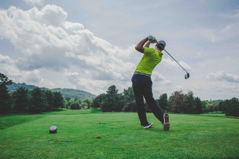 golfer driving the golf ball off the tee using a forgiving driver